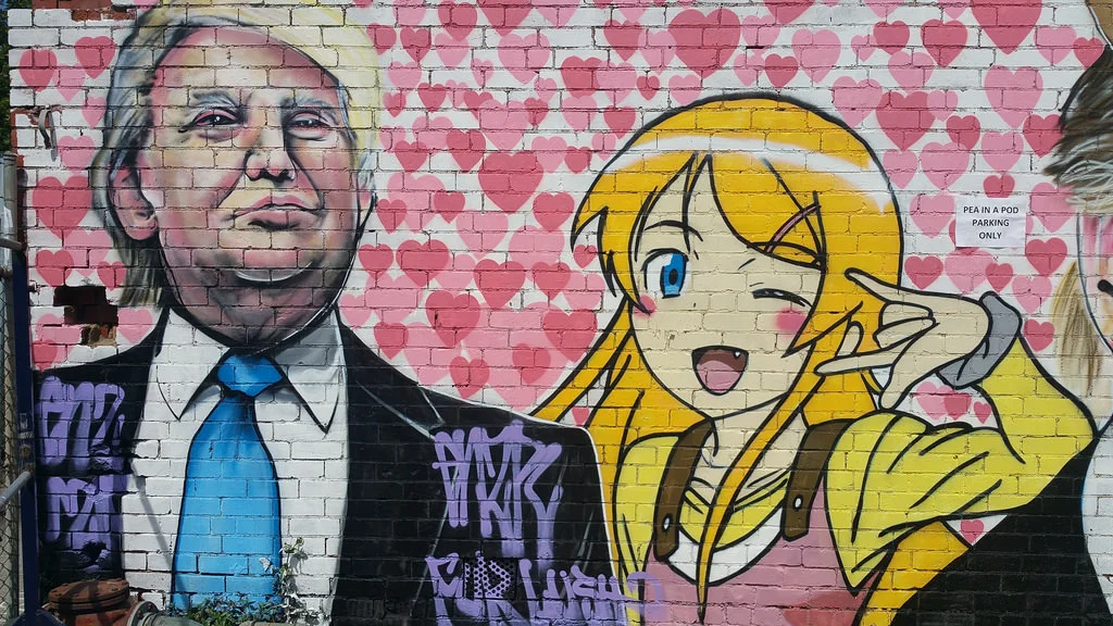 A Lushsux mural pairing Donald Trump with an anime waifu on a Brooklyn brick wall, a signature mashup style of the artist.