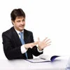 Stock photo businessman examining documents.