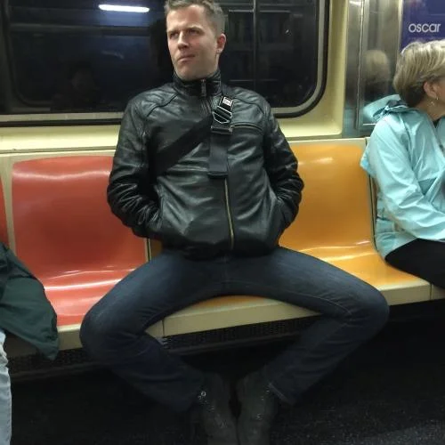 A subway rider illustrates the manspreading posture that sparked public campaigns against the practice.