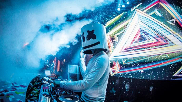DJ Marshmello performing live in his signature marshmallow helmet, the visual trademark that helped turn him into a global electronic music icon.
