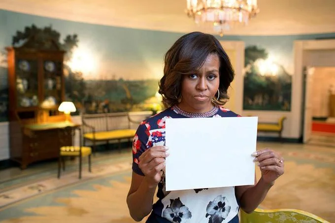 The original blank template photo of Michelle Obama holding a sign, widely used as a source for edited protest and joke images online.