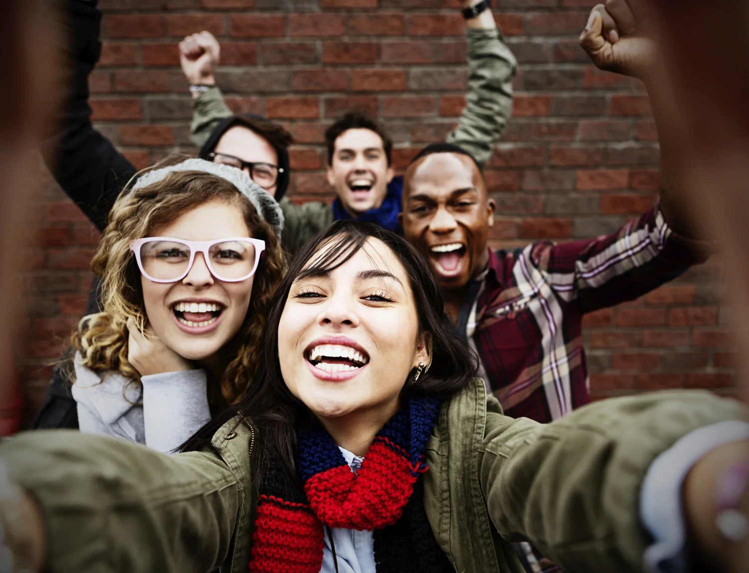 A stock photo of enthusiastic young millennials commonly used to illustrate articles about the generation.