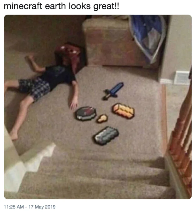 A satirical tweet mocking the augmented reality visuals of Minecraft Earth by staging a defeated player surrounded by cardboard cutouts of in-game loot.