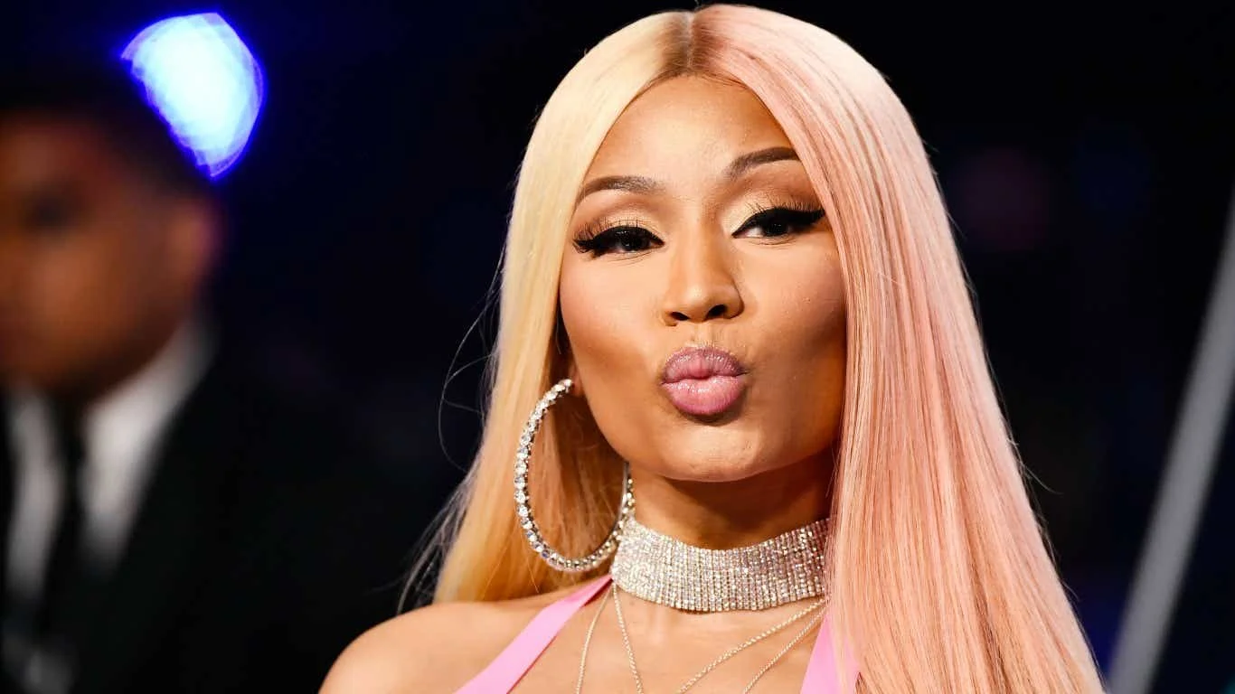 Nicki Minaj photographed at a red carpet event, striking her signature pouty pose.