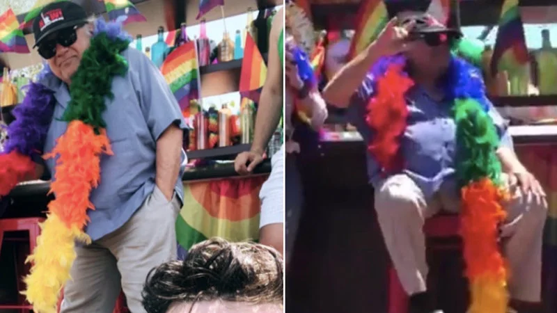 Danny DeVito in rainbow feather boas at Pride.