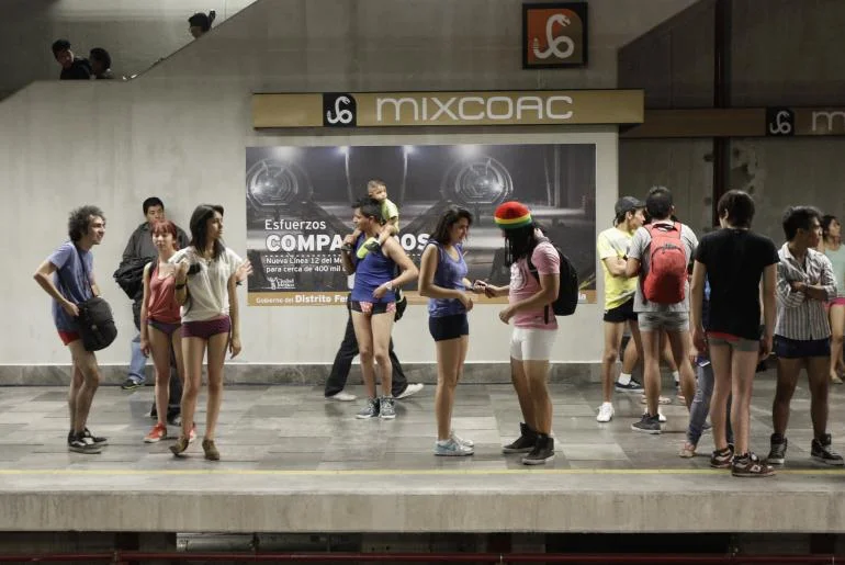 The No Pants Subway Ride draws a lively crowd to the Mixcoac Metro station in Mexico City, where participants mingle without trousers.