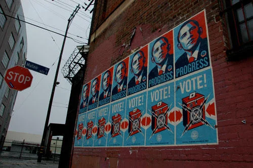 Obama Hope posters as street art on building.