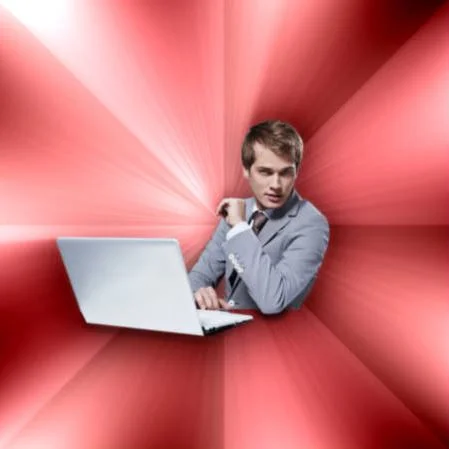 The original blank Overly Suave IT Guy image macro template, featuring the stock photo of a suited man at a laptop against a red radial background.