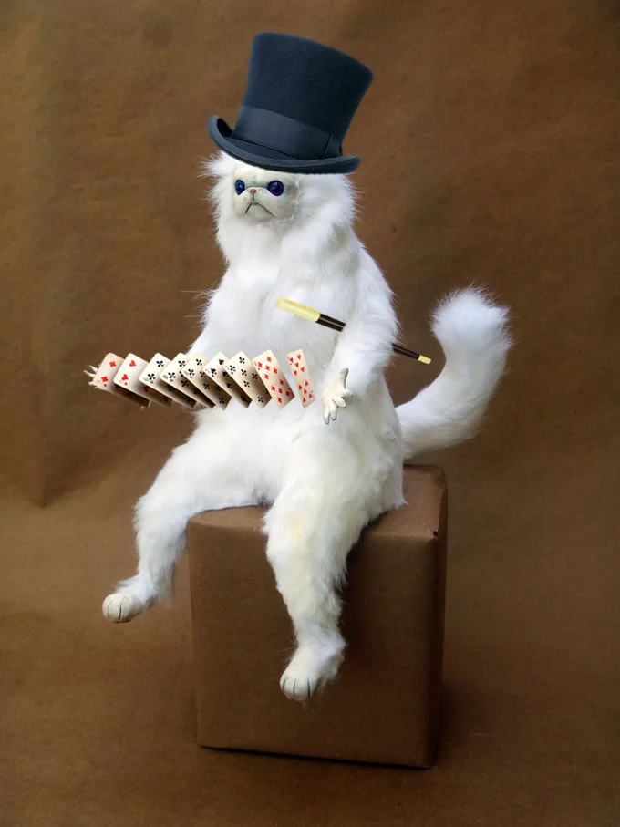 An alternate photograph of the Persian cat sculpture styled as a magician performing card tricks.