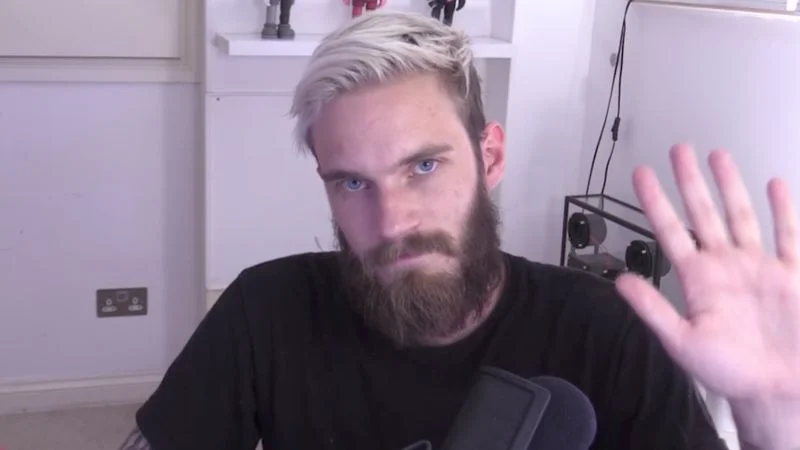 Felix 'PewDiePie' Kjellberg during one of his YouTube uploads, sporting his trademark bleached hair and beard.