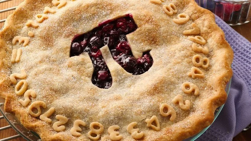 A Pi Day pie featuring the π symbol cut into the crust and digits of pi shaped from dough.