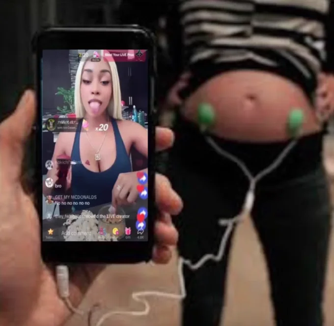 A surreal edit satirizing PinkyDoll TikTok LIVE consumption by depicting earbuds plugged into a bare stomach.