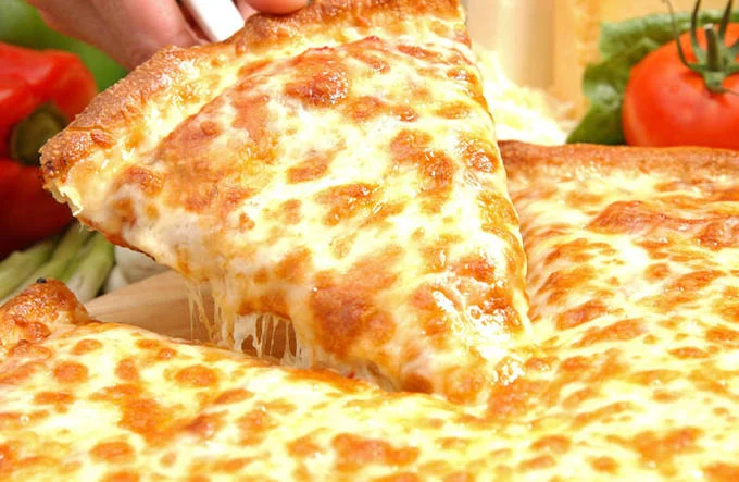 A classic cheese pizza slice with a signature cheese pull, the iconic image most often associated with the pizza meme.