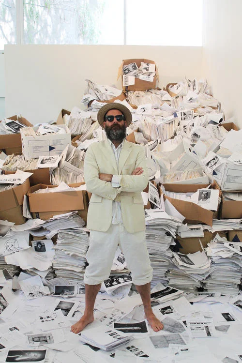 A promotional portrait of Goldsmith at the Printing Out the Internet installation.
