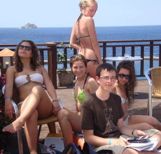 The original source photograph of Priority Peter, showing the studious teen ignoring the bikini-clad girls around him in favor of his calculator and notebook.