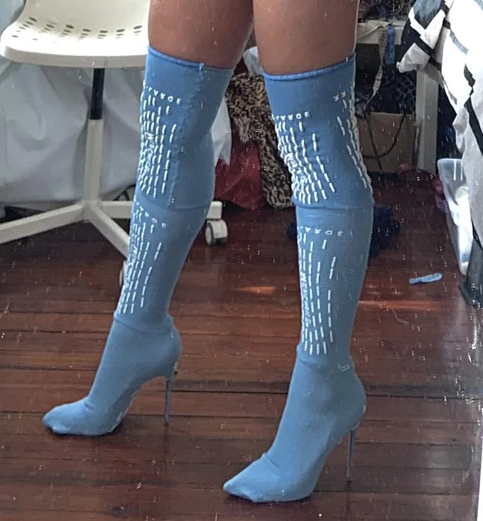 A fashion remix of the meme in which blue psych ward grippy socks have been turned into thigh-high stiletto boots.