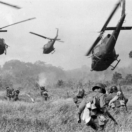 The original Vietnam War photograph of soldiers and Huey helicopters that forms the background of the PTSD Chihuahua meme.