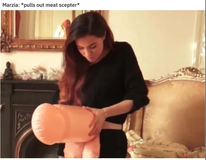A still of Marzia Bisognin brandishing an inflatable phallus, captioned with the signature 'pulls out meat scepter' roleplay line.