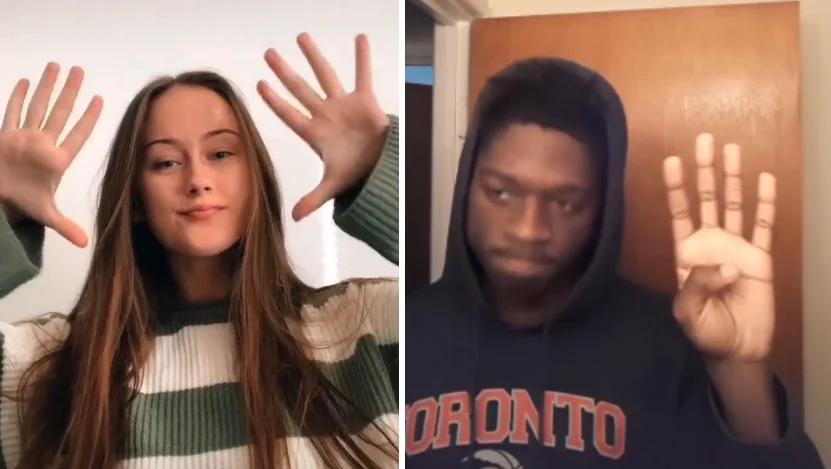 The iconic hands-up pose central to the Put a Finger Down challenge.