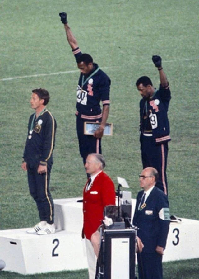 Historic 1968 Olympics Black Power salute protest with raised fists.