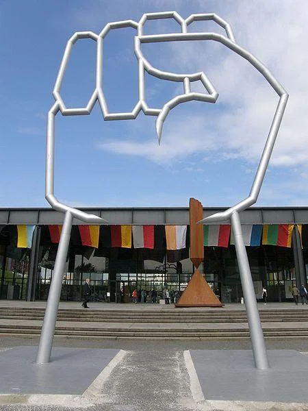 Large-scale metallic raised fist sculpture as civic public art installation.