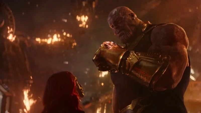 The definitive cinematic Thanos snap moment with iconic text.