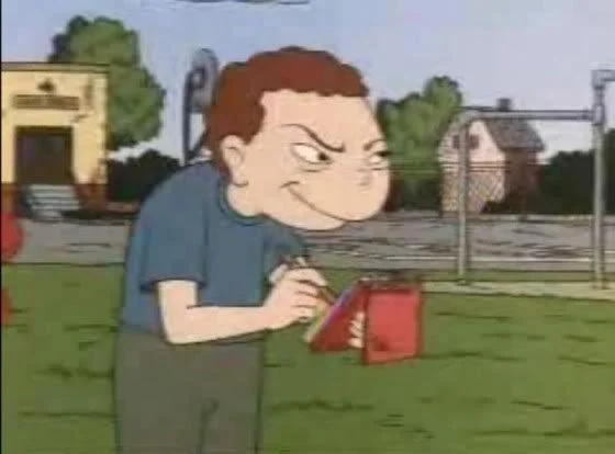 A screenshot from Recess featuring a bully character with a devious smirk, which became a popular reaction image online.