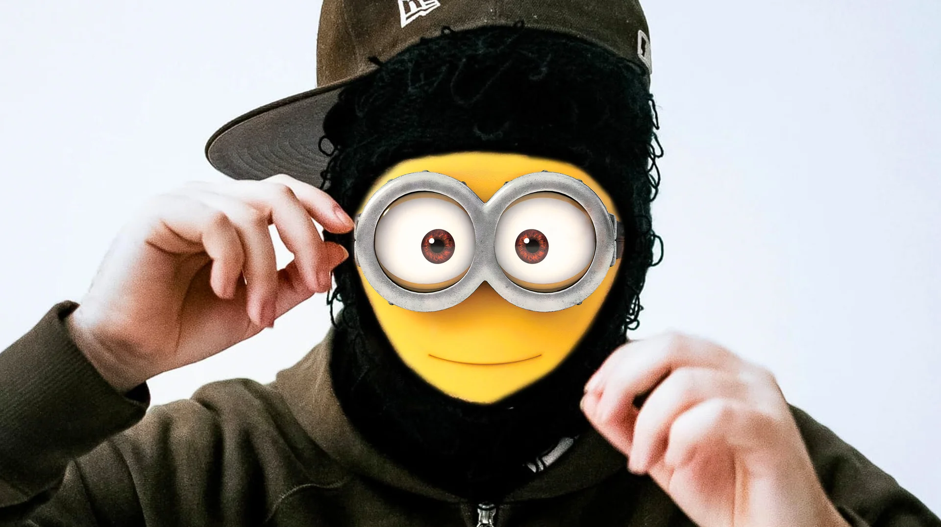 The primary 'Rich Minion by Yeat' meme image, pairing rapper Yeat's signature cap-and-ski-mask look with a Minion face overlay.