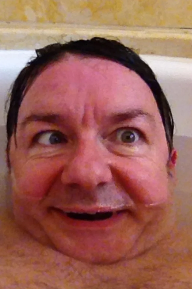 A second Ricky Gervais bathtub selfie showing another exaggerated funny face; part of a series he posted on social media.