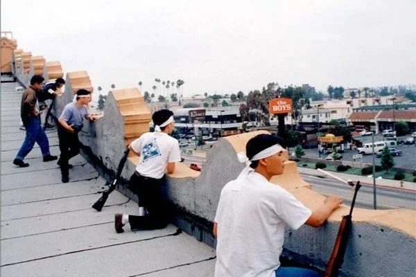 Iconic 1992 LA riots photograph of armed rooftop community self-defense.