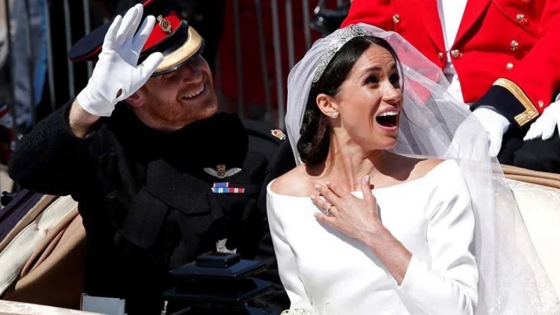 Prince Harry and Meghan Markle in the royal carriage following their May 2018 wedding, an image that became the centerpiece of countless viral reaction memes.