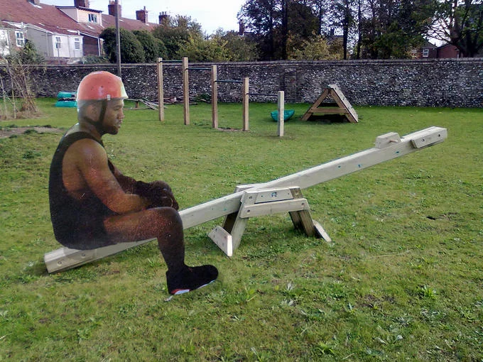 A photoshop edit depicting Sad Kanye alone on a seesaw, playing on the meme's theme of dejection and loneliness.