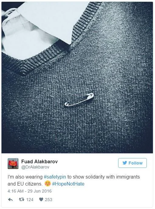 A tweet showcasing the safety pin worn in solidarity with immigrants and EU citizens, tagged with #HopeNotHate.
