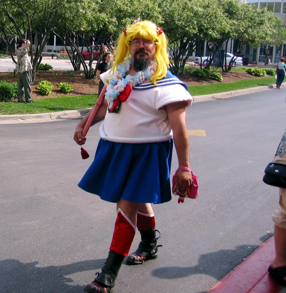 The original Sailor Bubba photograph, showing the bearded cosplayer in full Sailor Moon costume outside an anime convention.