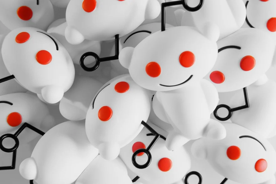 Snoo vinyl figurines, showcasing the Reddit mascot's classic design with white body, red eyes, and antenna.