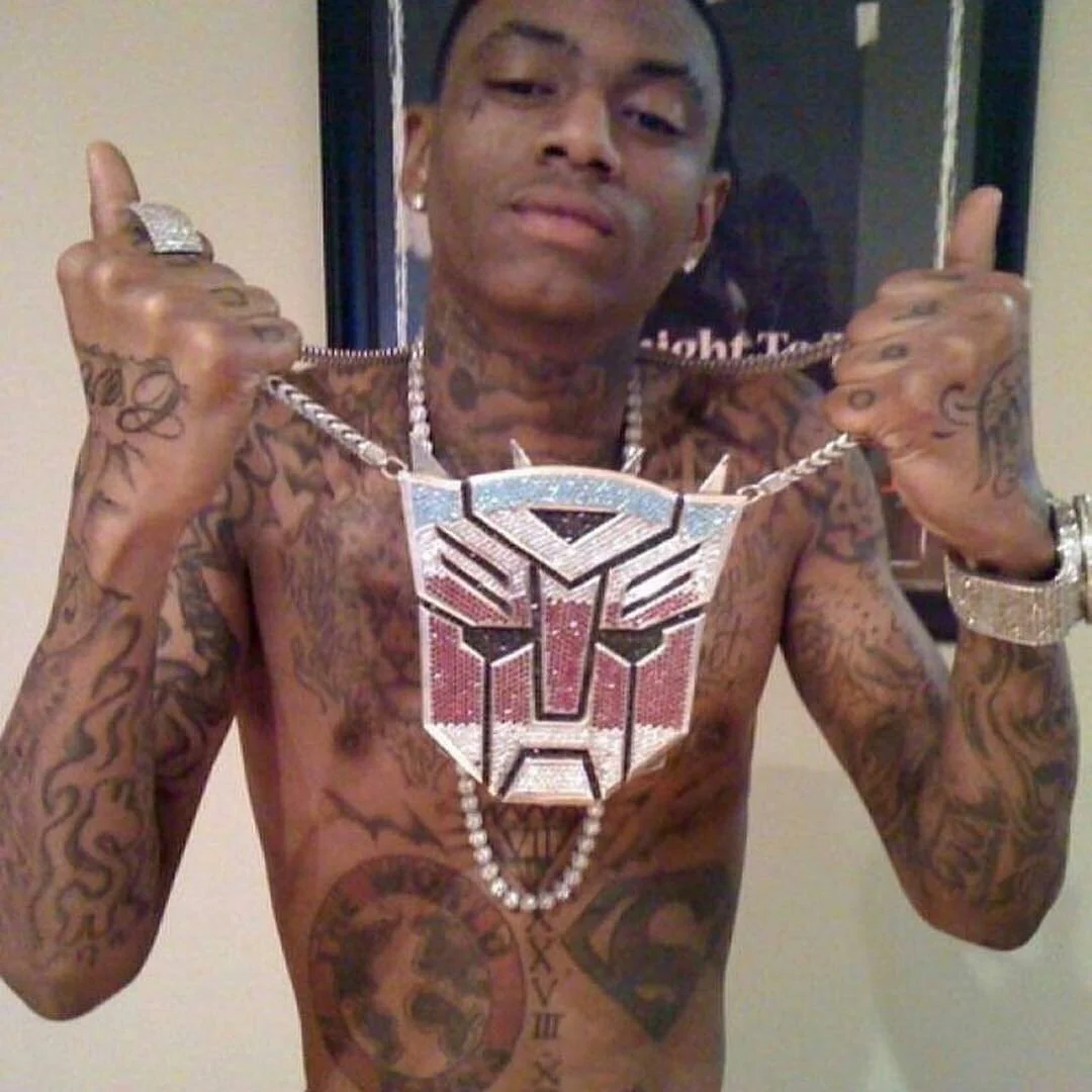Soulja Boy flaunting his infamous diamond Autobots pendant, one of the extravagant chains that helped cement his over-the-top rap persona.