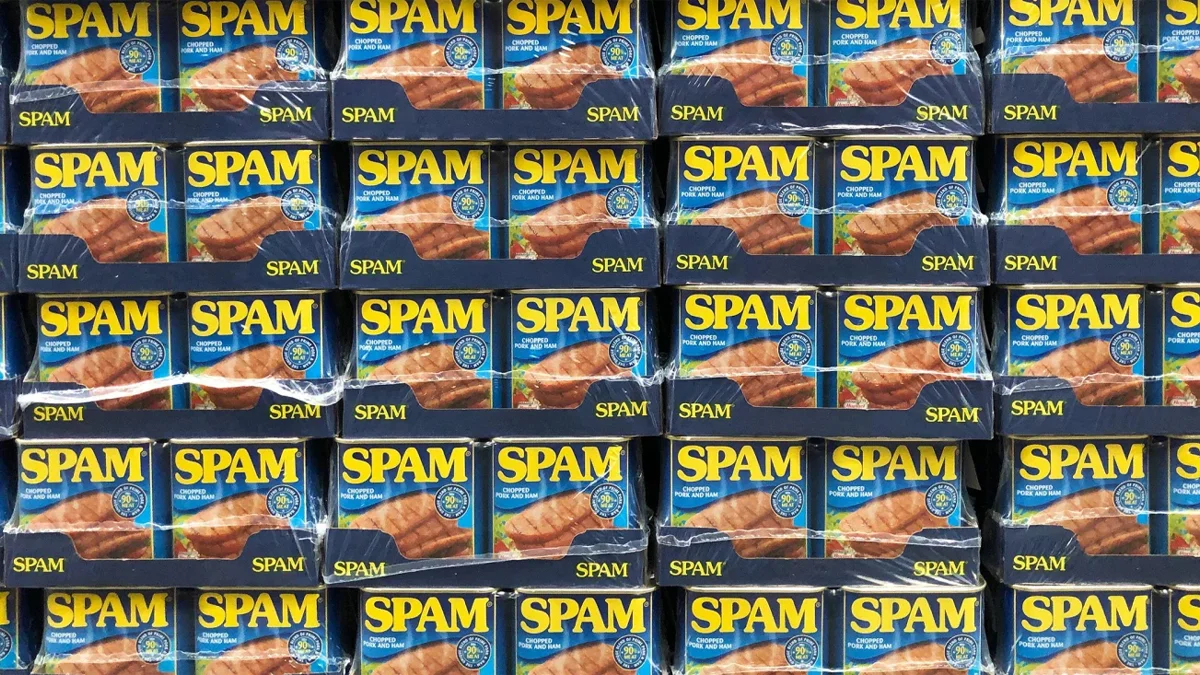 Stacks of Hormel's SPAM canned meat product, whose name became the origin of the term 'spam' used to describe unsolicited messages online.