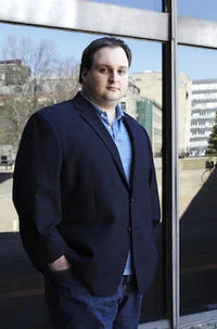 Adult photo near modern building.