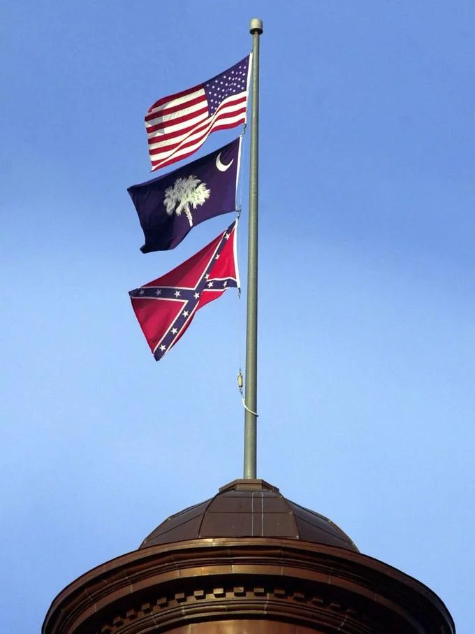 The Confederate flag flying beneath the U.S. and South Carolina flags at the state capitol, a focal point of the removal debate.
