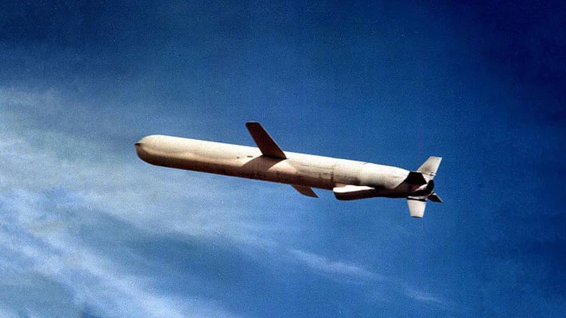 Cruise missile in flight against blue sky.