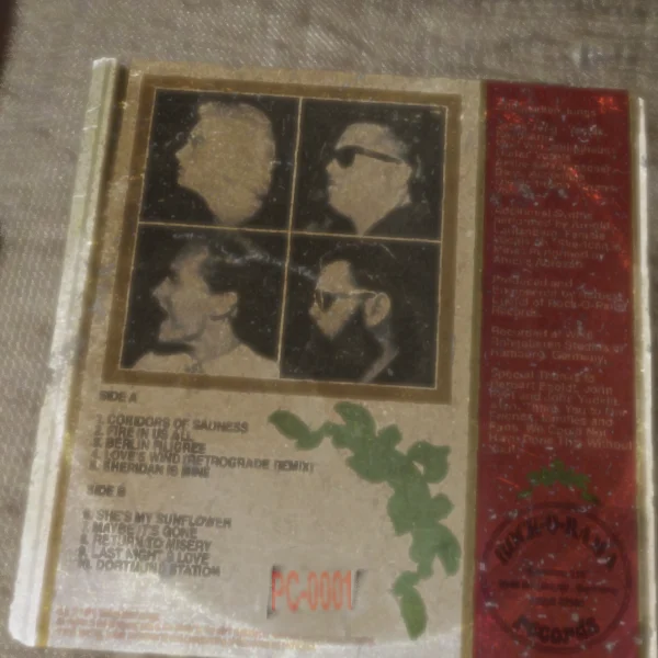Record back cover with band member photos.