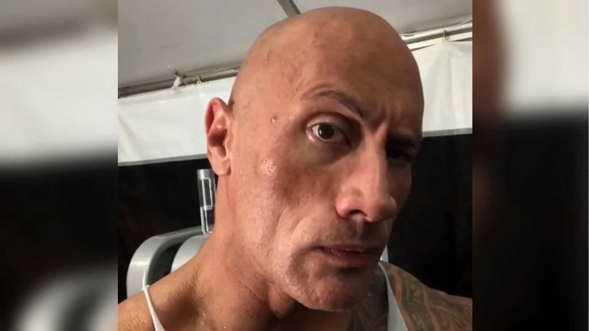 Dwayne 'The Rock' Johnson performs his signature raised-eyebrow look, the trademark expression behind the meme.