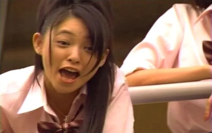 The original live-action still from the Japanese film that became the source image for the 'There's No Fucking Seat For You' meme.