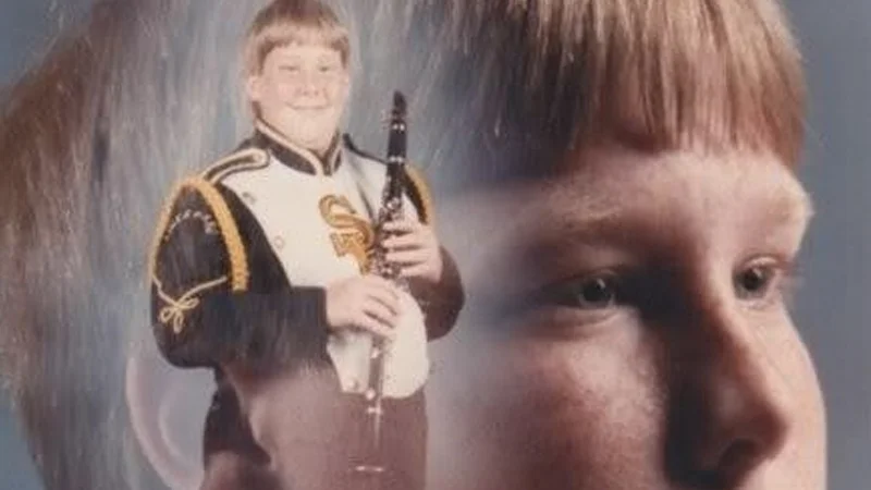 The original 'PTSD Clarinet Boy' school portrait that became the archetypal base image for the 'They Told Me I Could Be Anything I Wanted' meme.