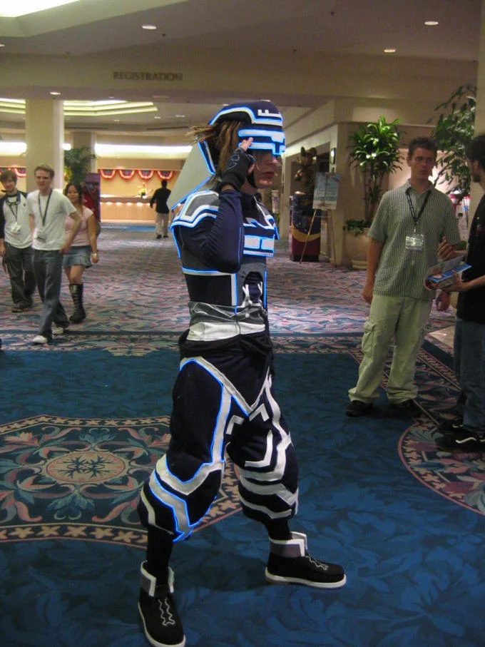 A convention attendee in homemade Tron-inspired cosplay featuring the franchise's trademark glowing circuitry.