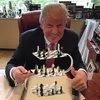 Trump posing with chess set reference.