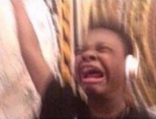 The original screaming boy with headphones image that became the foundation of the 'turn up the volume' meme.