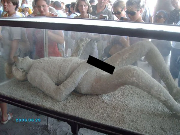 A Pompeii body cast given an unnecessary black censor bar, humorously implying nudity on an ancient preserved figure.
