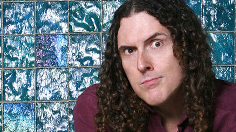 Portrait of musical parody artist 'Weird Al' Yankovic, whose long curly hair, glasses, and accordion have become iconic in internet culture.