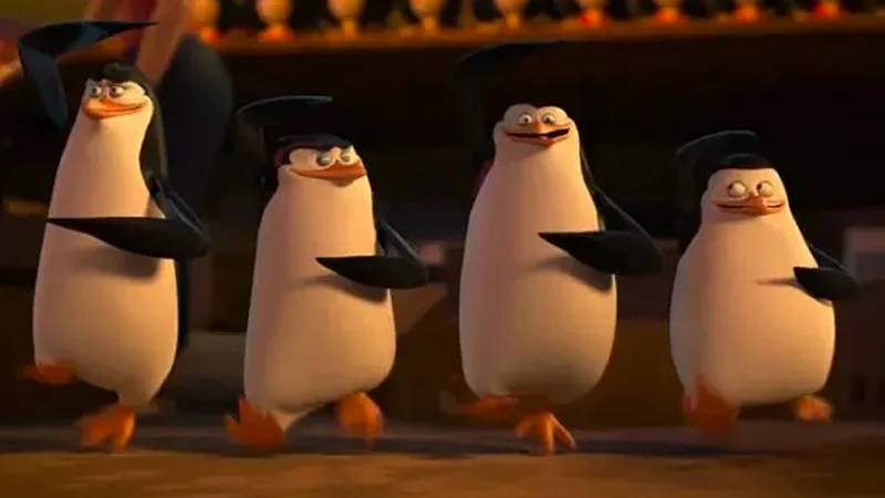 The source image: a still from 'Penguins of Madagascar' featuring the four penguins marching in triumphant formation, used as the base template for the 'Well boys, we did it, racism is no more' meme.